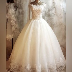 Beautiful natural colored almost white wedding dress size for never been used.